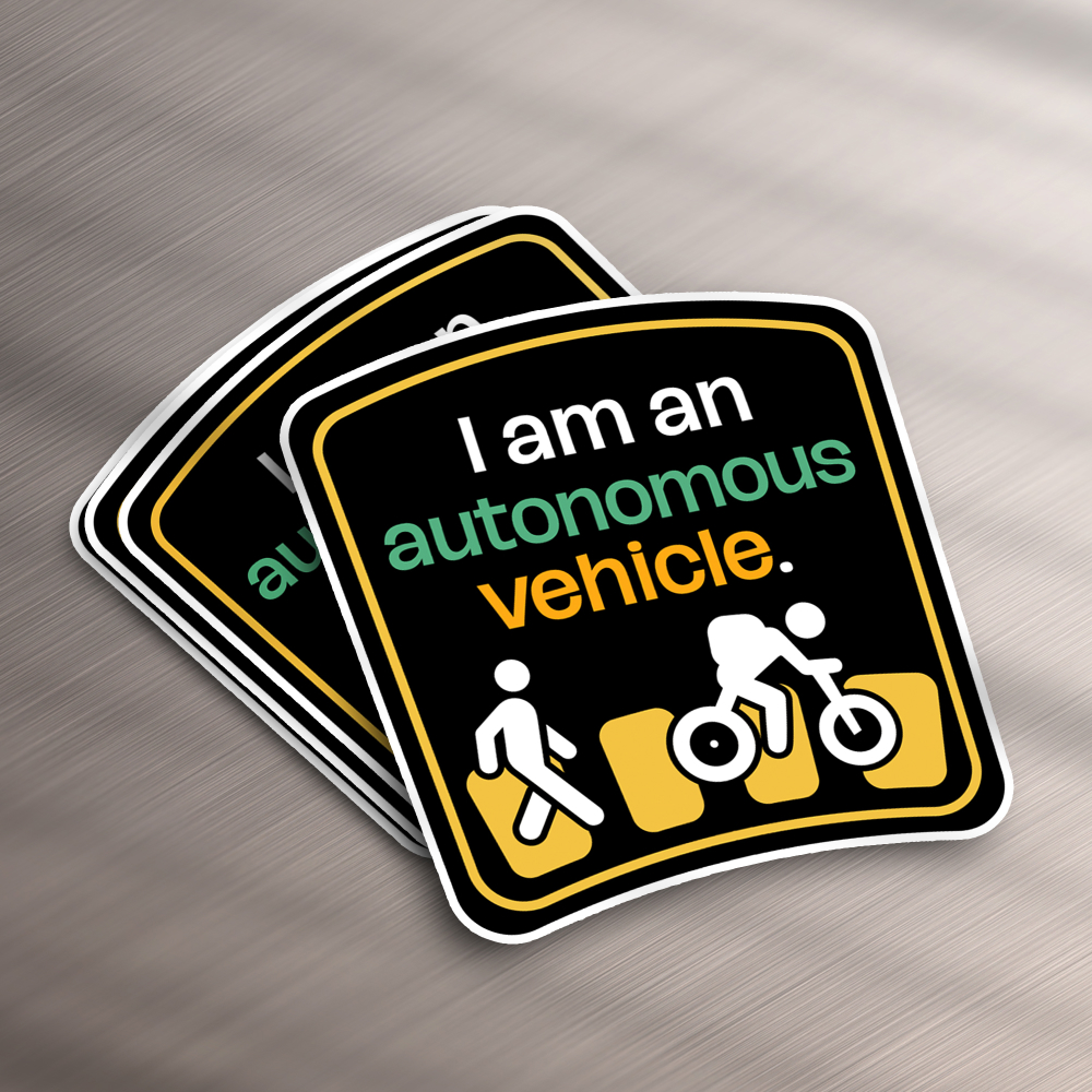 AI Startups 16 These stickers, perfect for a design subscription, flaunt a traffic-themed motif with I am an autonomous vehicle in white, green, and orange. Below this text, icons depict a pedestrian, cyclist, and car against a black backdrop framed in white.