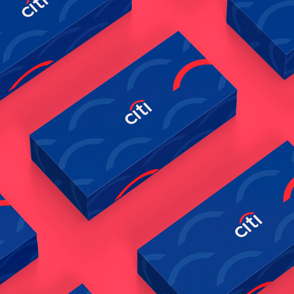 AI Startups 7 Blue gift boxes with a pattern of semicircles and the word citi are arranged on a pink surface. Each box features a red arc above the brand name, showcasing an eye-catching design subscription style.